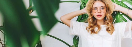 Girl wearing fashionable clothing surrounded by plants