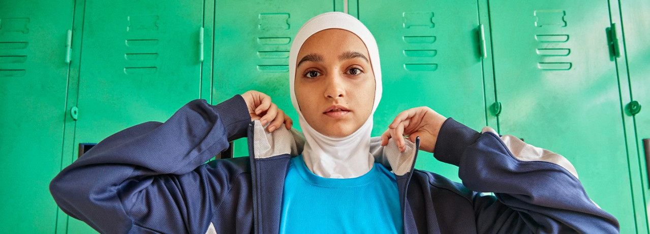 Person standing in front of green lockers