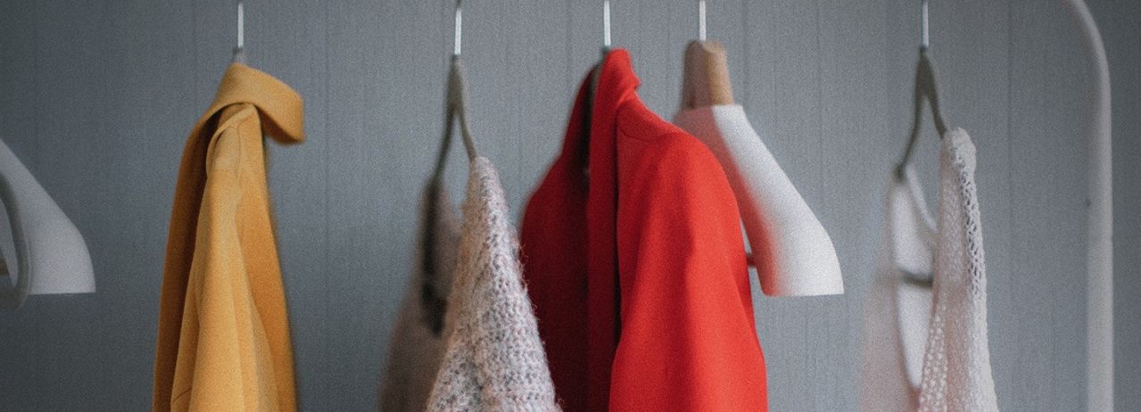 Colourful clothes in a wardrobe